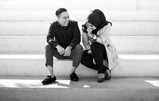 alt= "young lady sitting close to a guy to 'Know If He Loves you' and the lady is shy"